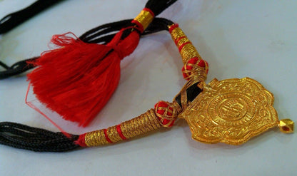 22KT yellow gold handmade tribal Shree Nathji pendant with intricate antique ethnic design from Rajasthan, India.