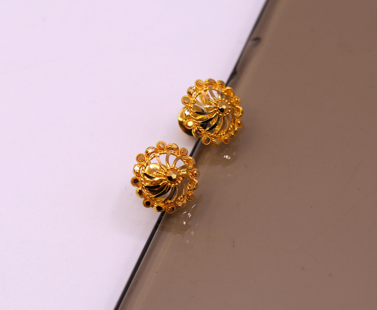 22Kt yellow gold handmade filigree stud earrings by TRIBAL ORNAMENTS, featuring intricate traditional Indian gold jewelry design.