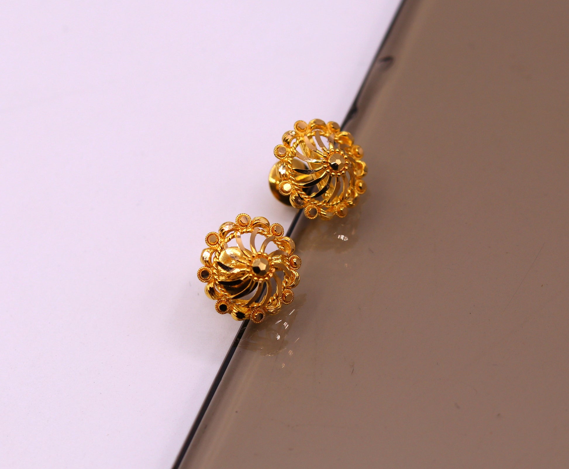 22Kt yellow gold handmade filigree stud earrings by TRIBAL ORNAMENTS, featuring intricate traditional Indian gold jewelry design.