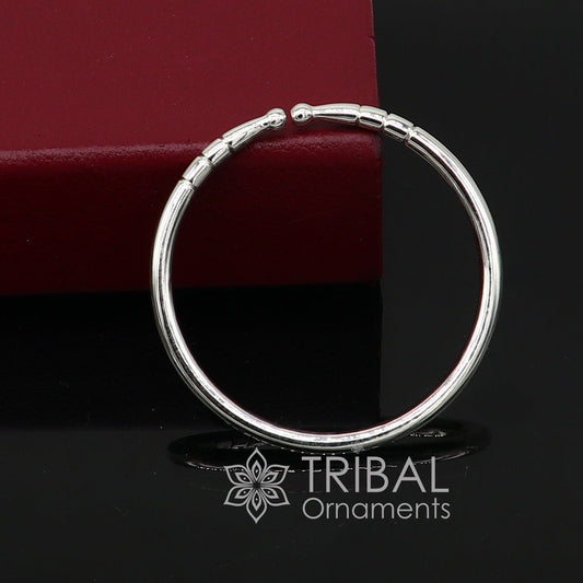 Sterling silver handmade bangle bracelet with plain shiny finish, adjustable unisex design, by TRIBAL ORNAMENTS.