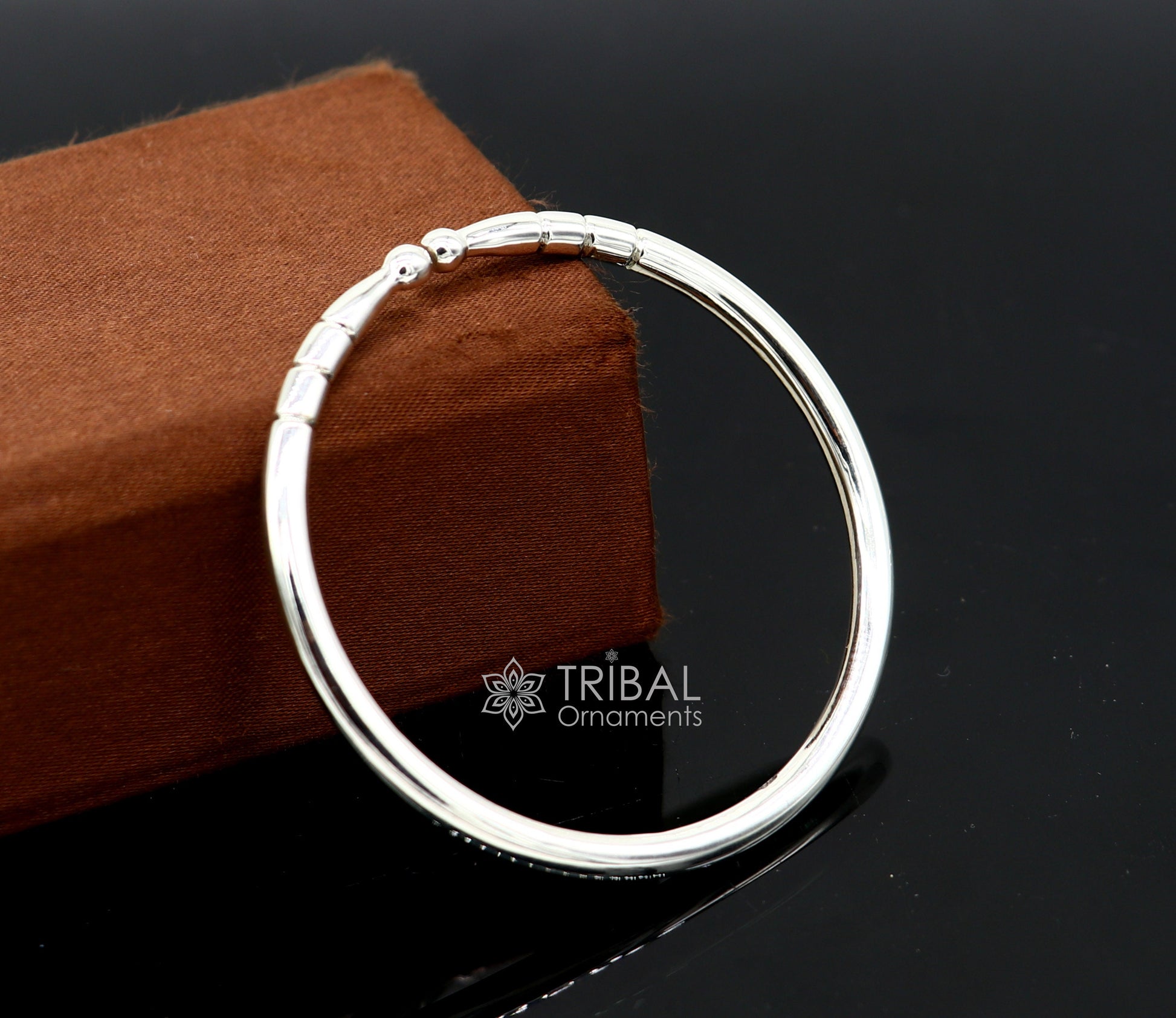 Sterling silver handmade bangle bracelet with a shiny finish, adjustable unisex kada design by TRIBAL ORNAMENTS.