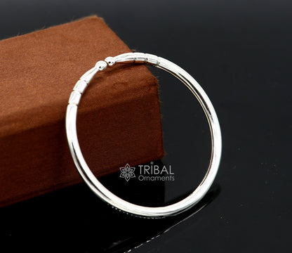 Sterling silver handmade bangle bracelet with a shiny finish, adjustable unisex kada design by TRIBAL ORNAMENTS.