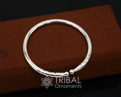 Sterling silver handmade bangle bracelet with a shiny, plain design, adjustable and trendy for unisex wear by Tribal Ornaments.