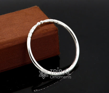 Sterling silver handmade bangle bracelet with a shiny, plain design, adjustable and unisex, by Tribal Ornaments.