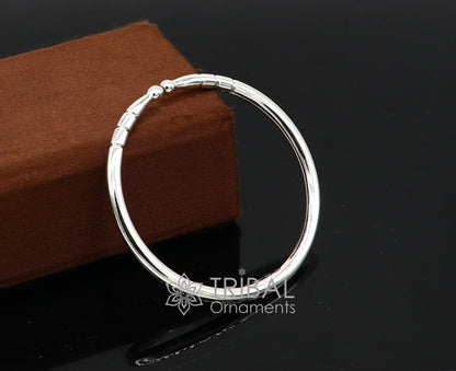 Sterling silver handmade bangle bracelet with a shiny, plain design, adjustable unisex kada by TRIBAL ORNAMENTS.