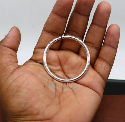 Sterling silver kids bangle bracelet by Tribal Ornaments, adjustable shiny plain design for unisex babies and children.