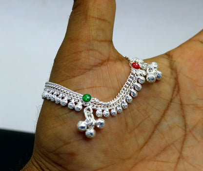 Handmade sterling silver vintage-style baby ankle bracelet with noisy bell charms, featuring intricate design and delicate craftsmanship.