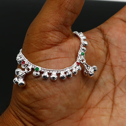 Handmade sterling silver vintage-style baby ankle bracelet with noisy bells and charm, featuring delicate design and traditional craftsmanship.