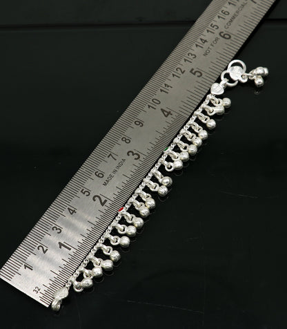 Handmade 5.5-inch sterling silver baby anklet with waved design and jingling bells, crafted by TRIBAL ORNAMENTS for kids.