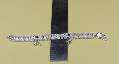 Sterling silver baby ankle bracelet with jingling charm, customized 5.5-inch length, delicate foot jewelry for newborns by TRIBAL ORNAMENTS.
