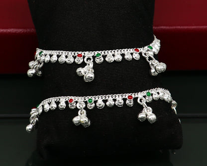 Handmade sterling silver vintage-style baby ankle bracelet with noisy bells and charm, featuring delicate design and traditional craftsmanship.