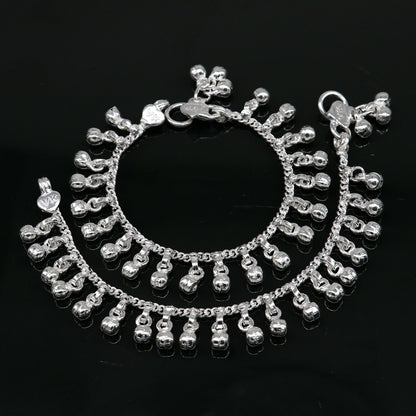 Sterling silver vintage baby anklet with 5.5-inch waved hanging bells, handmade tribal design, and charm accents.