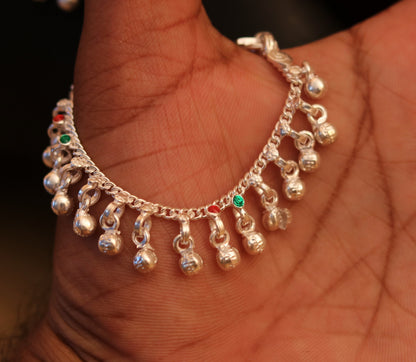 Sterling silver handmade baby ankle bracelet with sound charm from Rajasthan, India, featuring intricate tribal design and traditional craftsmanship.