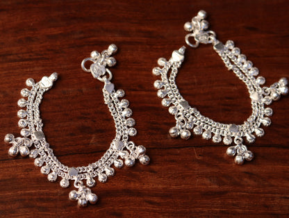 Sterling silver baby anklet with hanging noisy bells, handmade unisex jewelry, featuring a small baby foot charm.