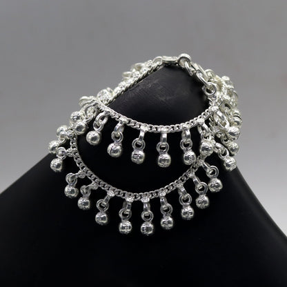 Sterling silver handmade baby ankle bracelet with noisy charm from Rajasthan India, featuring intricate tribal design and silver craftsmanship.