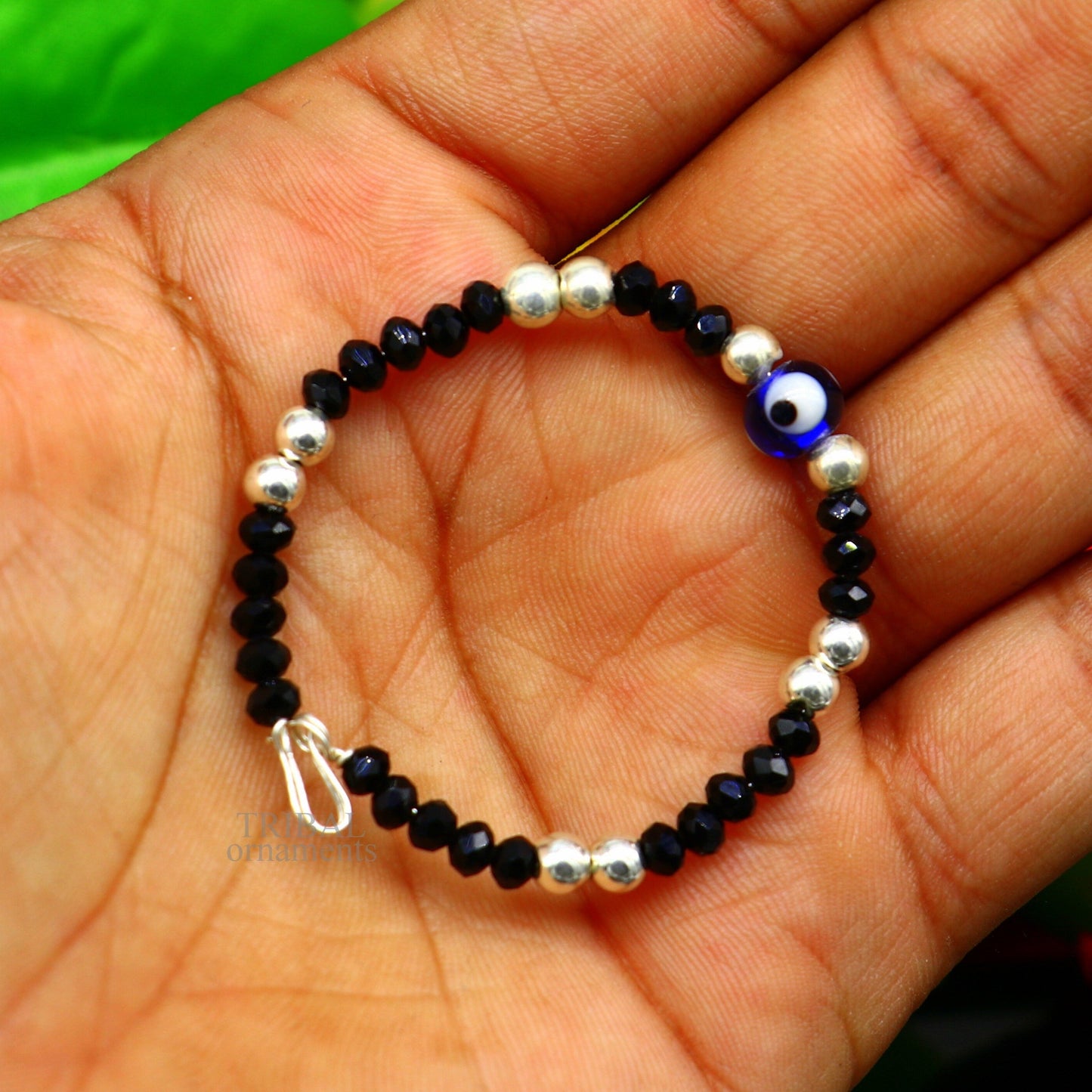 Sterling silver handmade beaded evil eye bracelet by TRIBAL ORNAMENTS, stylish unisex kids jewelry with blue and silver beads.