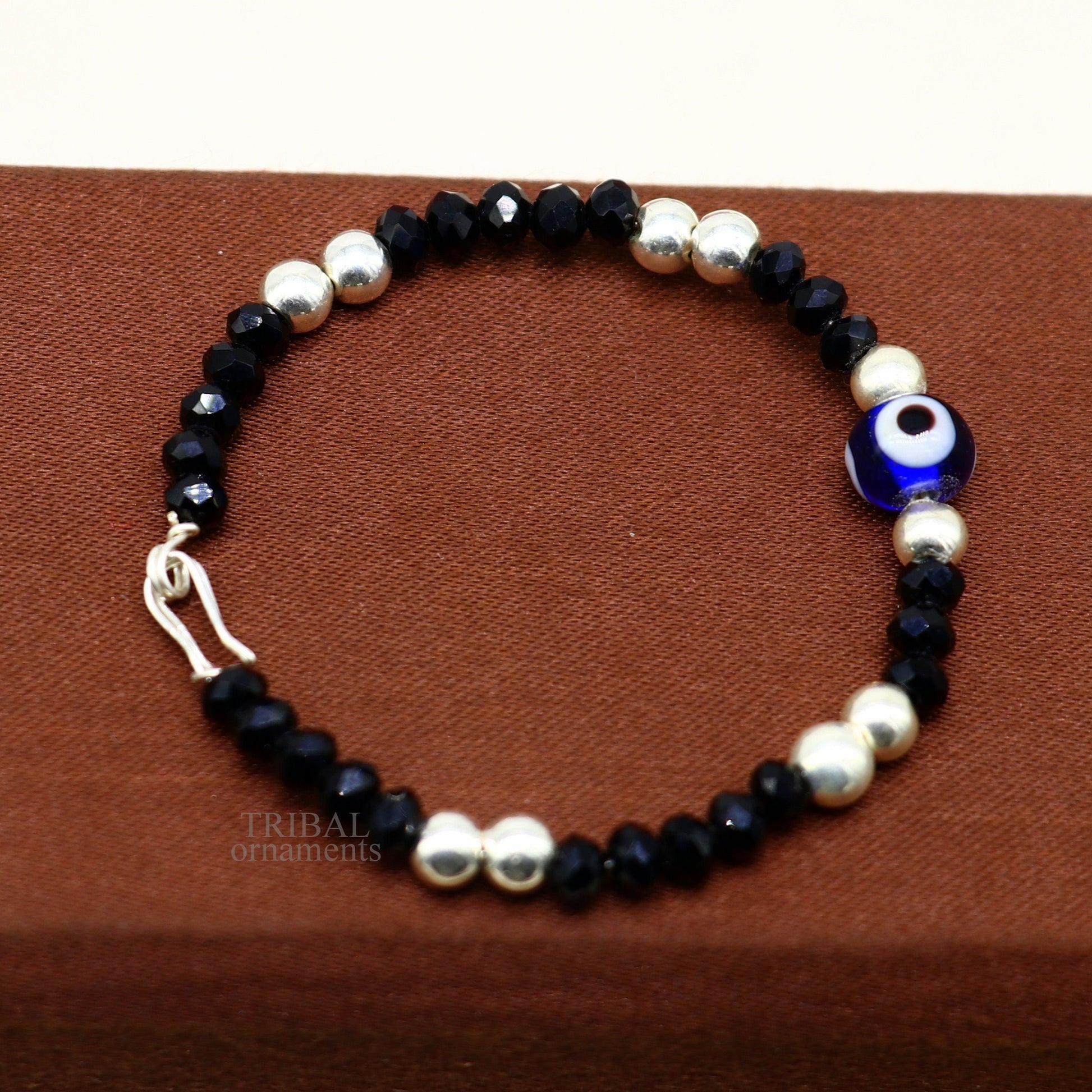 Sterling silver handmade beaded evil eye bracelet by TRIBAL ORNAMENTS, stylish unisex kids jewelry with colorful beads and protective charm.
