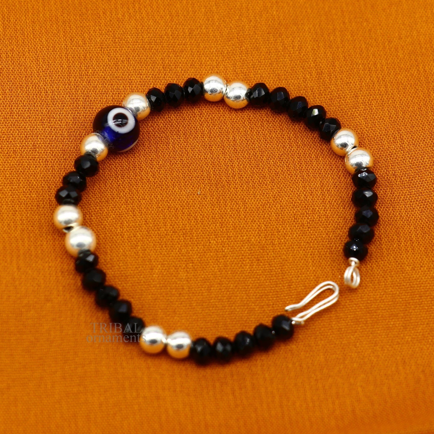 Sterling silver handmade beaded evil eye bracelet by TRIBAL ORNAMENTS, stylish unisex kids jewelry with colorful beads and protective charm.