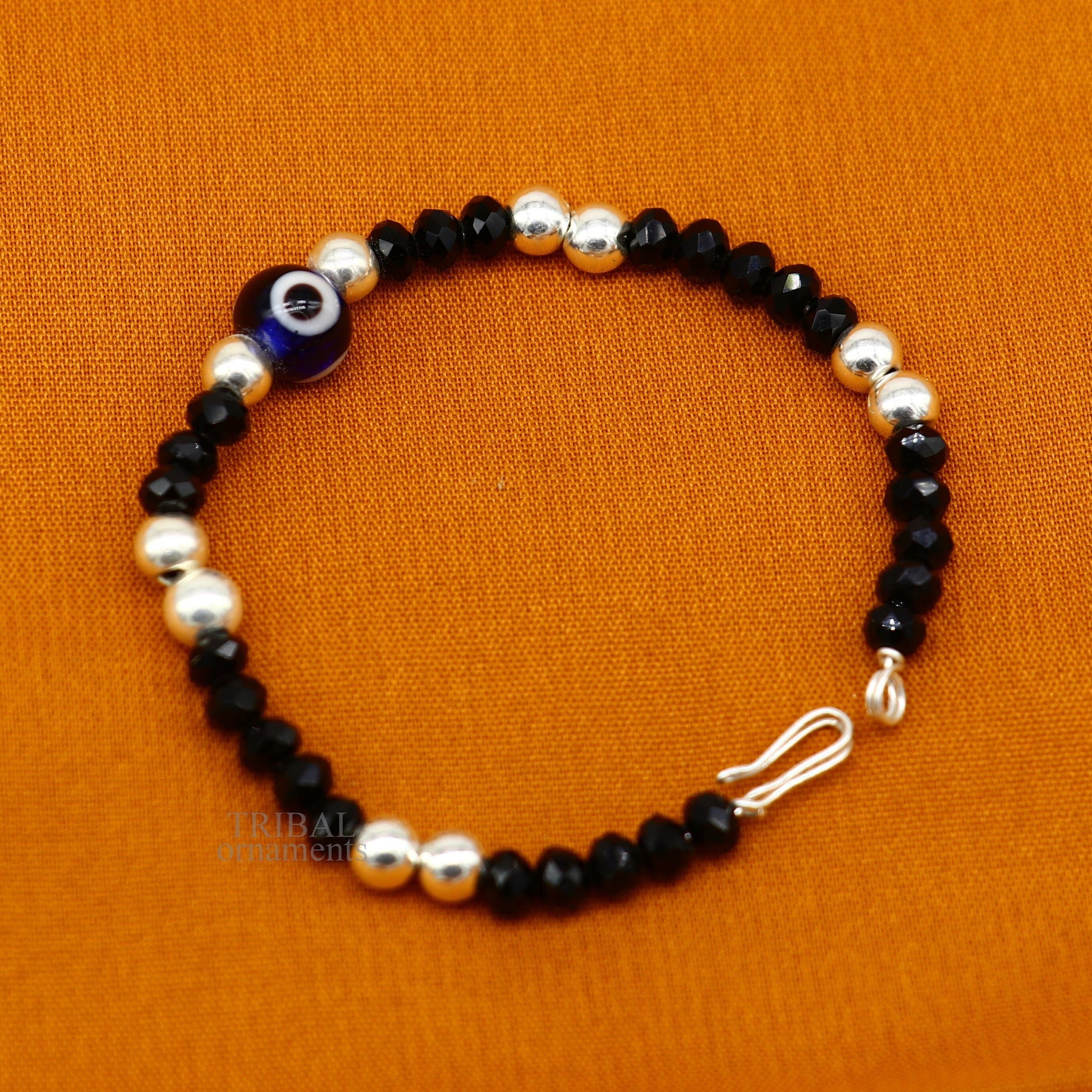 Sterling silver handmade beaded evil eye bracelet by TRIBAL ORNAMENTS, stylish unisex kids jewelry with colorful beads and protective charm.