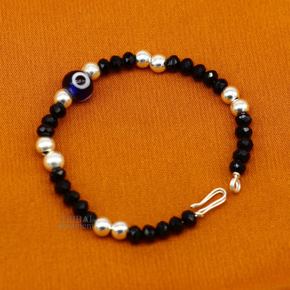 Sterling silver handmade beaded evil eye bracelet by TRIBAL ORNAMENTS, stylish unisex kids jewelry with colorful beads and protective charm.