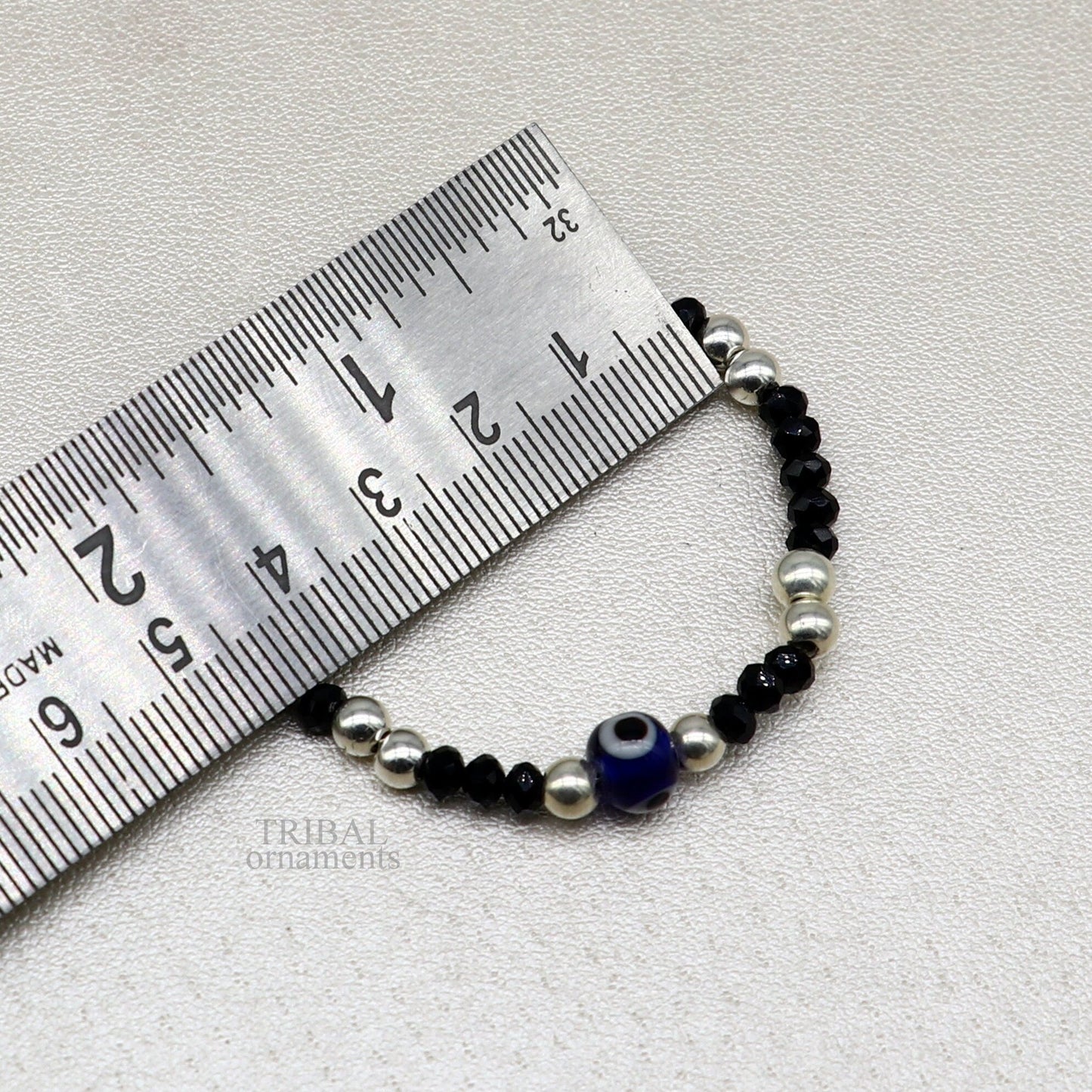 Sterling silver handmade beaded evil eye bracelet by TRIBAL ORNAMENTS, stylish unisex kids jewelry with colorful beads and protective charm