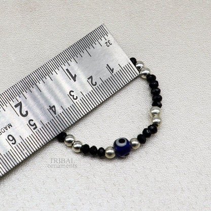 Sterling silver handmade beaded evil eye bracelet by TRIBAL ORNAMENTS, stylish unisex kids jewelry with colorful beads and protective charm