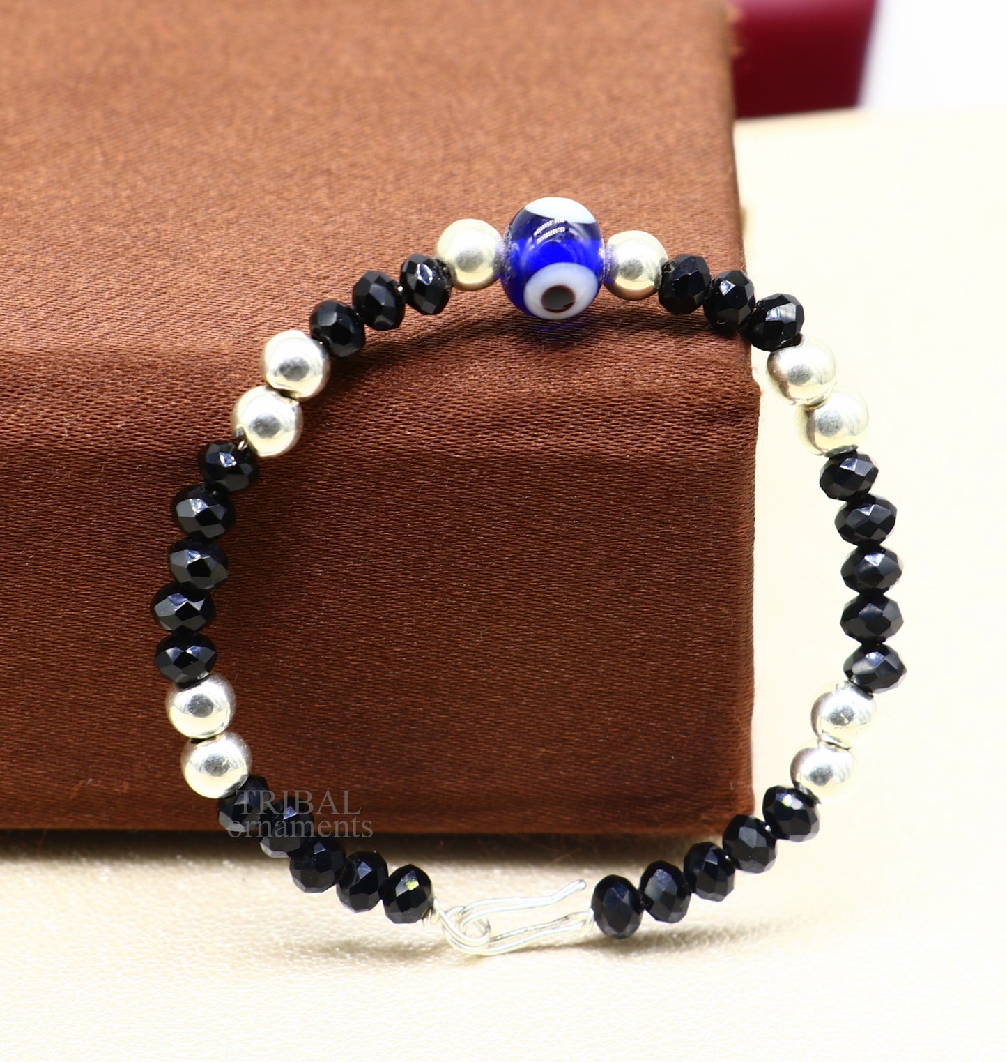 Sterling silver handmade beaded evil eye bracelet by TRIBAL ORNAMENTS, unisex kids jewelry, stylish and protective accessory.