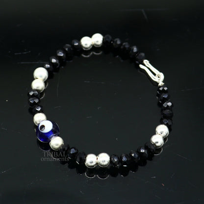 Sterling silver handmade beaded evil eye bracelet by Tribal Ornaments, stylish unisex kids jewelry with blue eye charm.