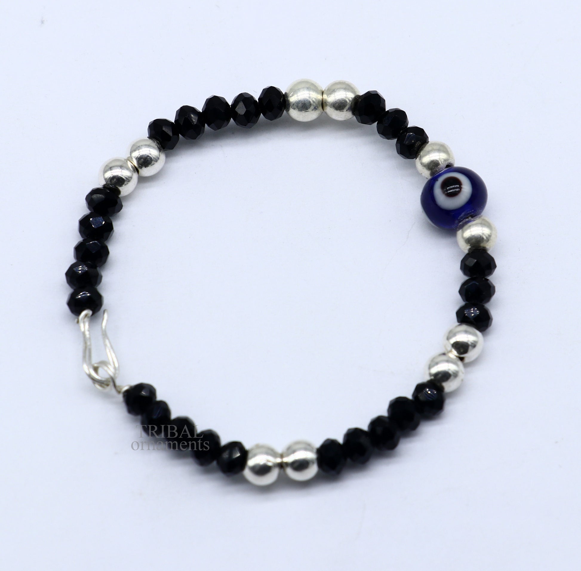 Sterling silver handmade beaded evil eye bracelet by TRIBAL ORNAMENTS, stylish unisex kids jewelry with vibrant beads and protective evil eye charm.