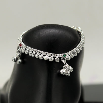 Handmade 5-inch sterling silver baby ankle bracelet with dainty charm, unisex design, elegant and customizable by TRIBAL ORNAMENTS.