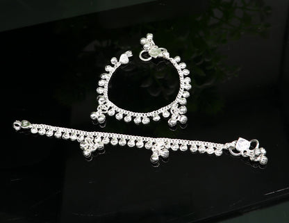 Handmade 5-inch sterling silver baby ankle bracelet with dainty charms, unisex and customizable, from Tribal Ornaments.
