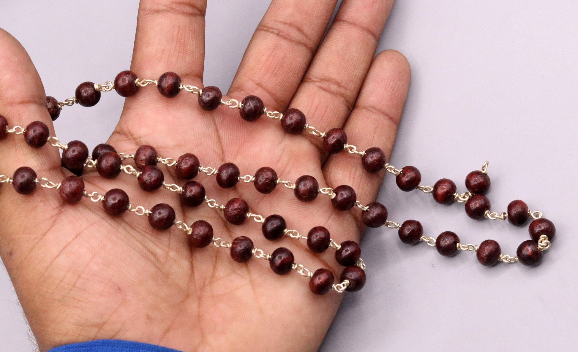 Red sandal chandan jaap mala with 54 beads on a 925 sterling silver chain, tribal jewelry from India for prayer and spiritual rituals.