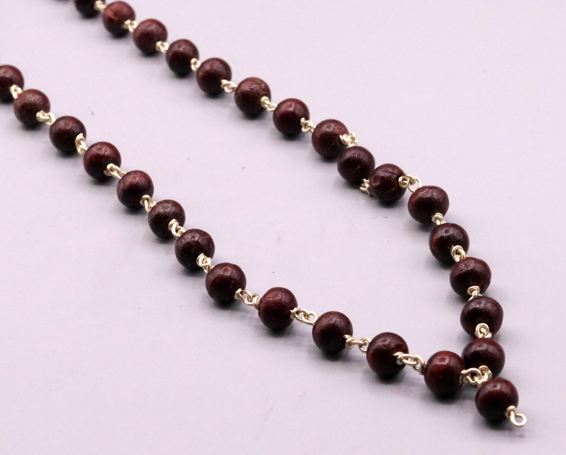 Red sandal chandan jaap mala with 54 beads on a 925 sterling silver chain, regional tribal jewelry from India.