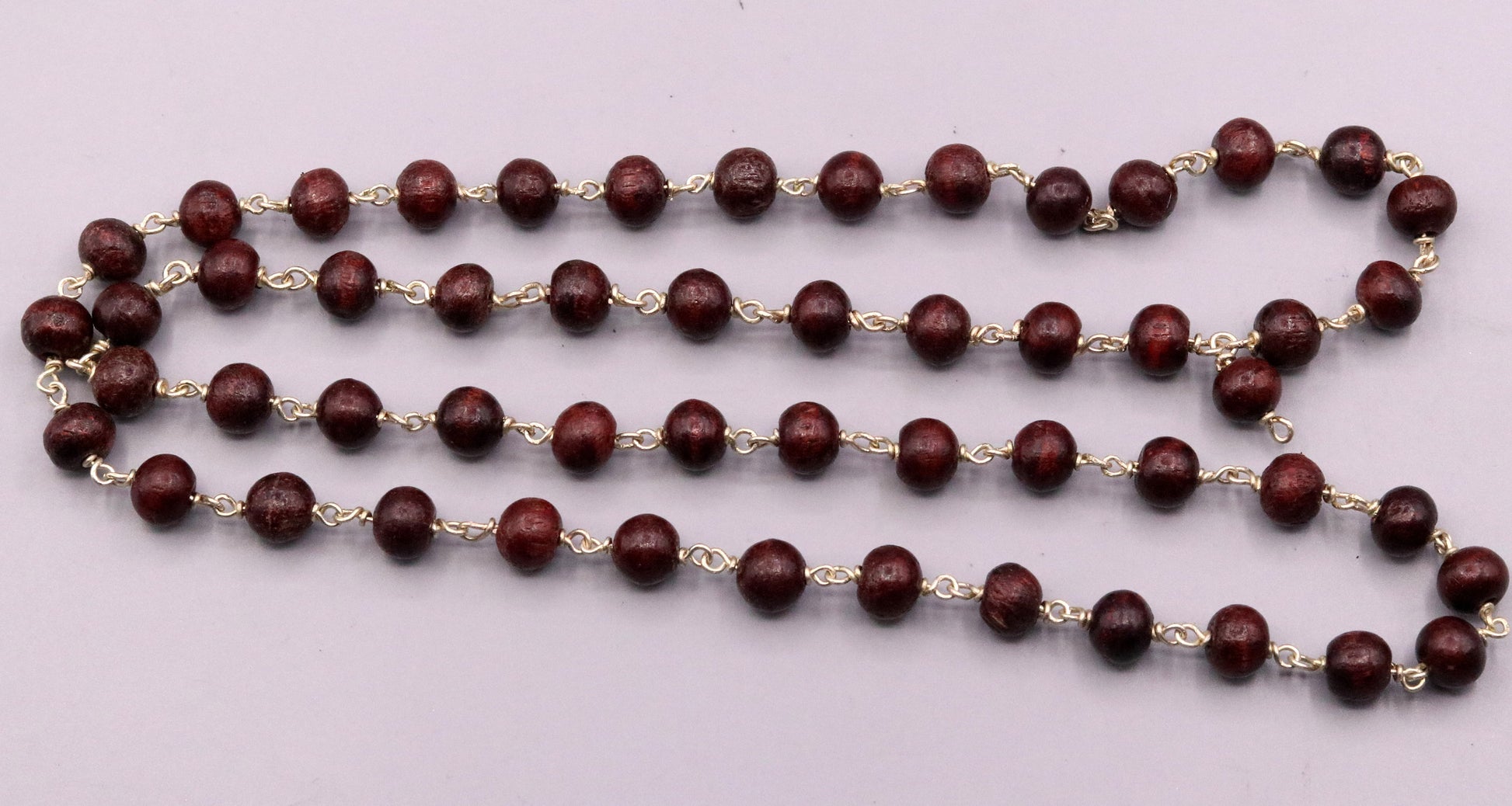 Red sandal chandan bead prayer mala with 925 silver chain, tribal jewelry from India, featuring 54 beads for spiritual worship.