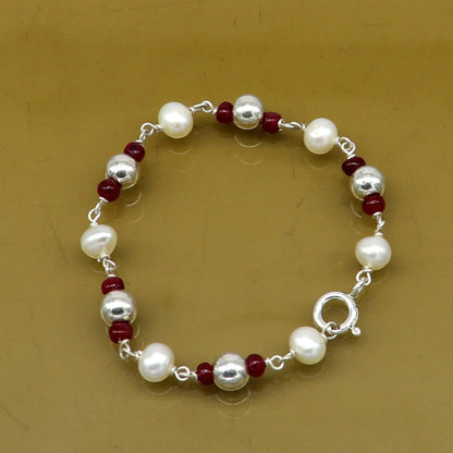 Sterling silver and pearl beaded baby bracelet by TRIBAL ORNAMENTS, handcrafted newborn jewelry with customizable design.
