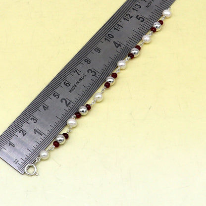 Sterling silver and pearl beaded baby bracelet by Tribal Ornaments, handmade newborn jewelry with customizable design.