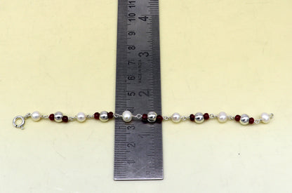 Sterling silver and pearl beaded baby bracelet by TRIBAL ORNAMENTS, handmade and customized for newborns, featuring 5mm beads.