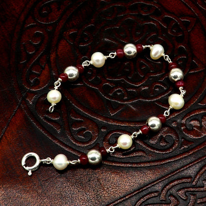 Sterling silver and pearl beaded baby bracelet by TRIBAL ORNAMENTS, handmade with customizable design for newborns and infants.