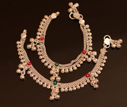Handmade sterling silver baby anklet with small charms and noisy bells, unisex foot bracelet with delicate design.