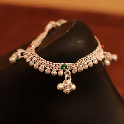 Sterling silver baby anklet with hanging noisy bells, unisex design, handcrafted by Tribal Ornaments, featuring a delicate baby foot charm.