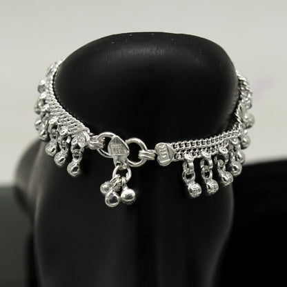 Sterling silver handmade baby anklet by Tribal Ornaments with hanging noisy bells and charm, unisex foot bracelet for infants.