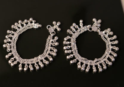 Sterling silver handmade baby ankle bracelet with jingle bells, charm accents, and traditional Indian belly dance jewelry style.