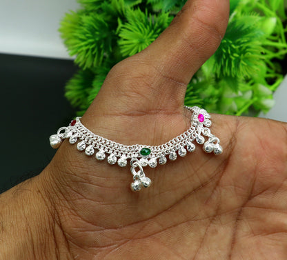 Handmade sterling silver anklet with jingling bells, designed for kids, featuring a baby foot charm from Tribal Ornaments.