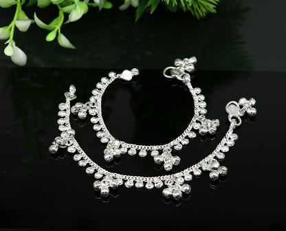 Handmade sterling silver baby ankle bracelet with dainty charms, adjustable length, unisex design, crafted by Tribal Ornaments.