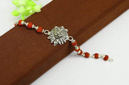 Sterling silver lion design beaded bracelet with Rudraksha beads, custom jewelry by TRIBAL ORNAMENTS, ideal for rakhi gifting.