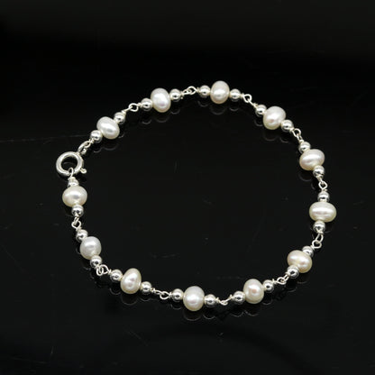Handmade 7.5-inch sterling silver beaded bracelet with natural pearl accents, unisex jewelry from Tribal Ornaments.
