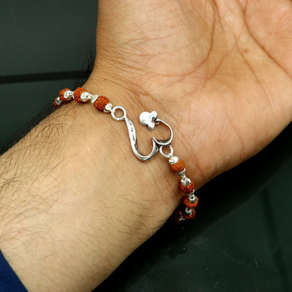 Sterling silver OM design Rudraksha bracelet with custom details, handmade by TRIBAL ORNAMENTS, 7.5-inch length, solid silver jewelry