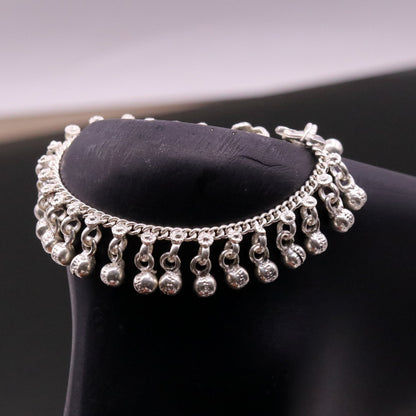 Vintage sterling silver baby anklet with hanging bells and charm design, featuring a 7-inch length and handmade tribal craftsmanship.