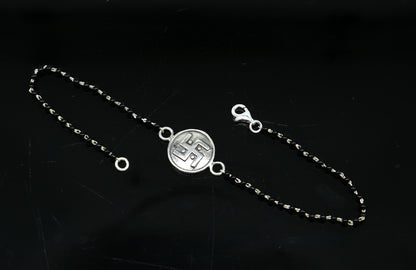 8.5-inch sterling silver customized black beaded Swastik bracelet by TRIBAL ORNAMENTS featuring intricate design and traditional symbols.