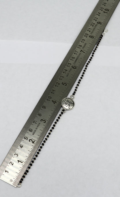 Sterling silver 8.5-inch black beaded Swastik bracelet by TRIBAL ORNAMENTS featuring customizable design and intricate beaded details.